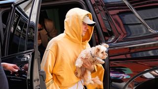 Justin Bieber holding his dog