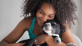 Young woman hugging her dog