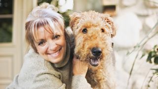 Woman hugging Airedale Terrier